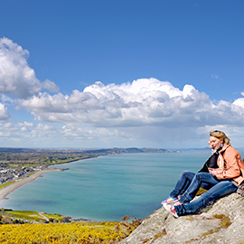 two women view Bray Ireland from elevated overlook